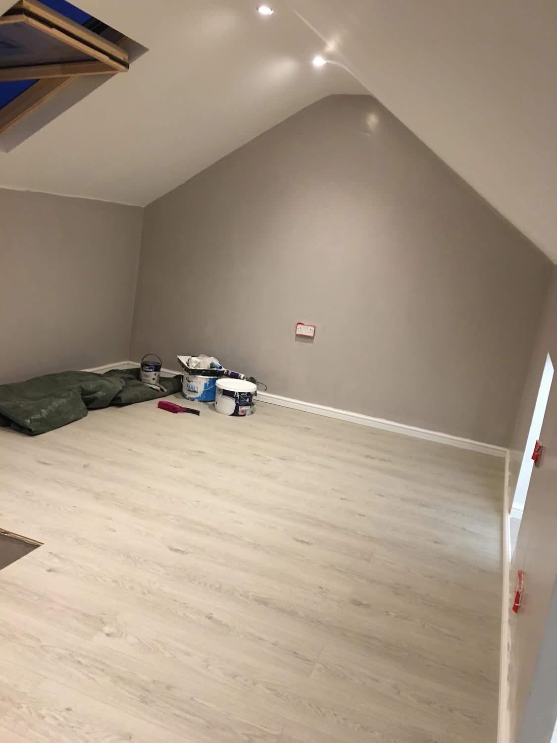Completed loft room with skylight, fresh plaster and new laminate flooring