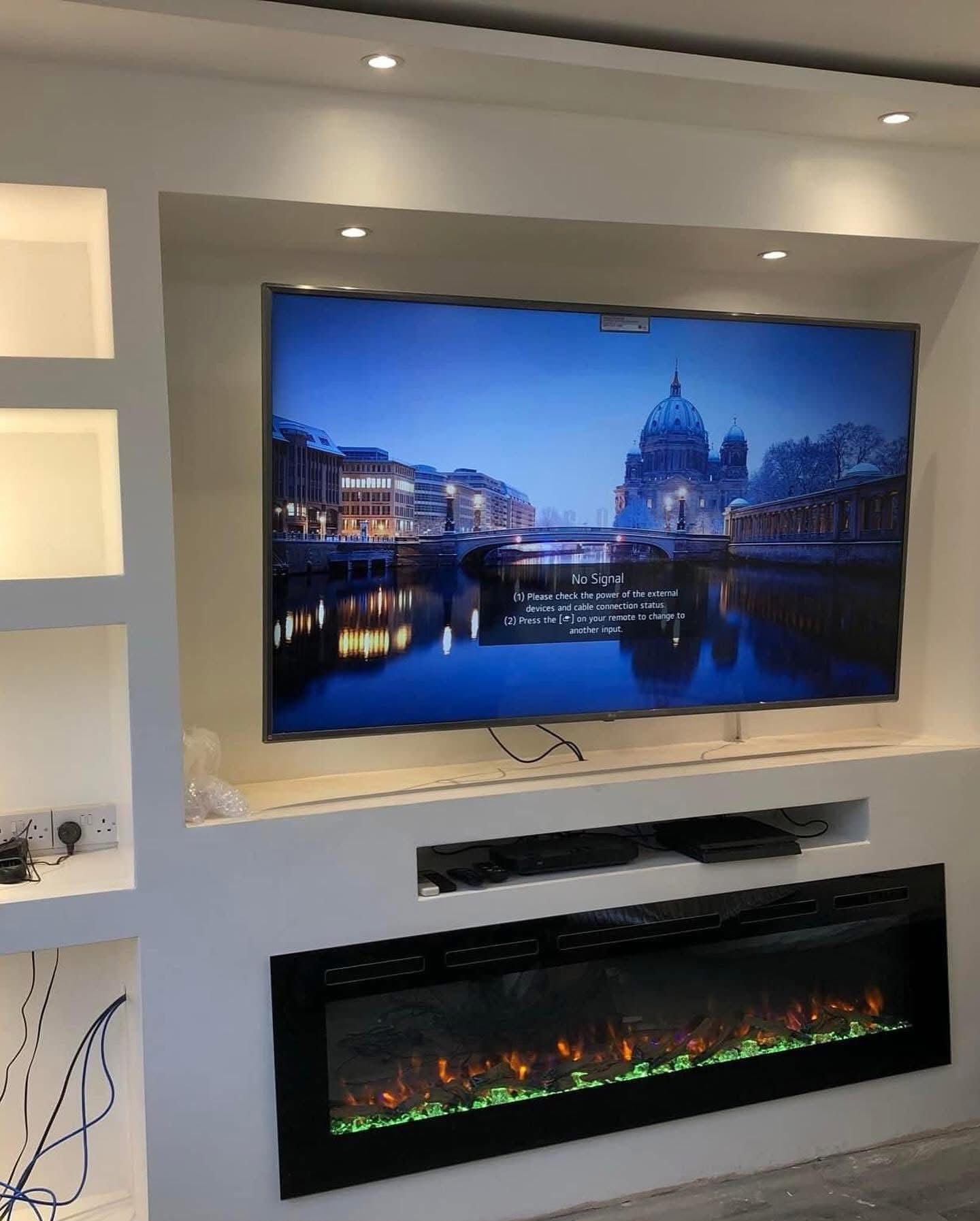 Bespoke media wall with electric fireplace and recessed lighting, built by Roshi