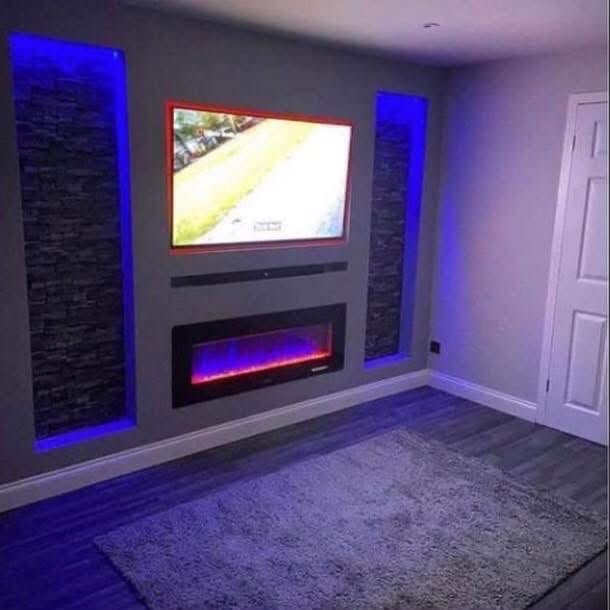 Bespoke media wall with electric fireplace, mounted TV and blue LED lighting