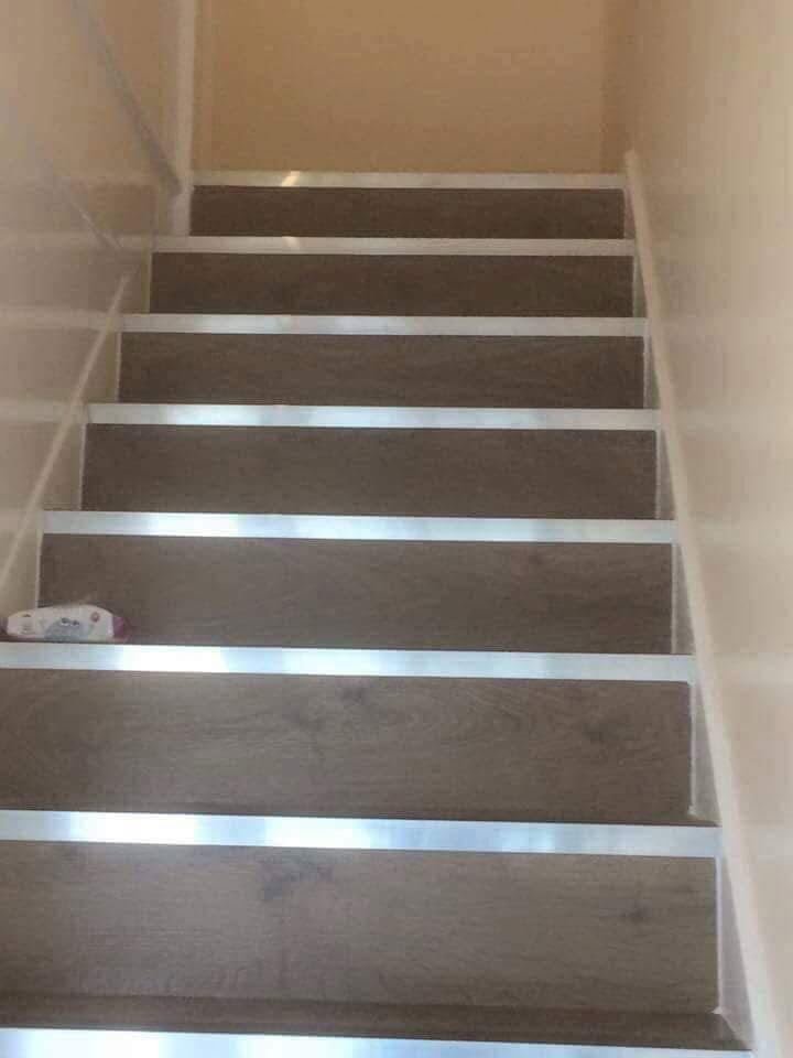 Laminate-clad staircase with brushed metal nosings